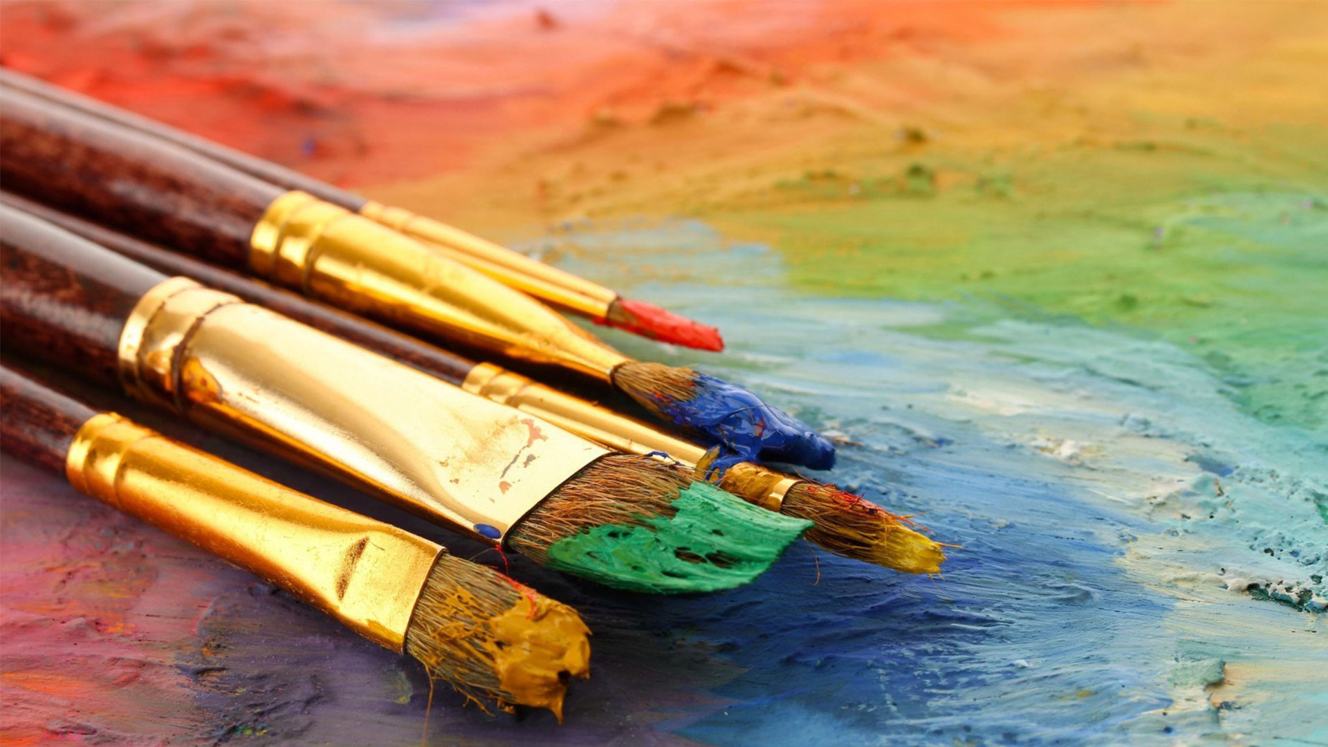 Paint brushes and colours on a painter's palette